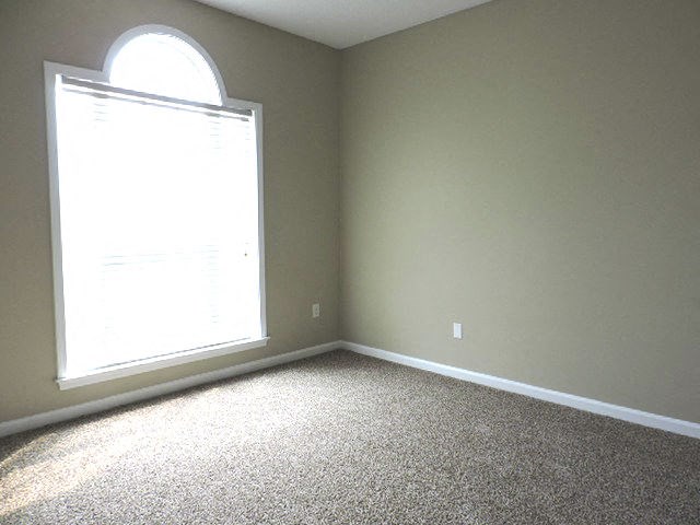 an empty living room with a large window