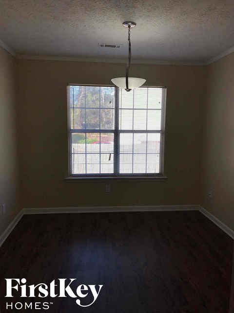 an empty living room with a large window