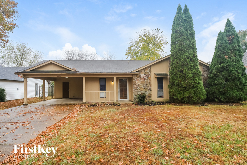 the front of a house with a yard and a driveway