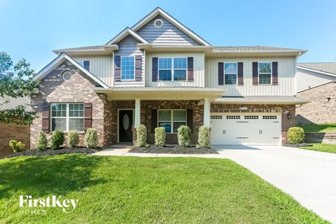 a large house with a garage and a lawn