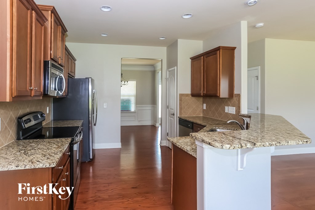 a kitchen with granite counter tops and wooden cabinets