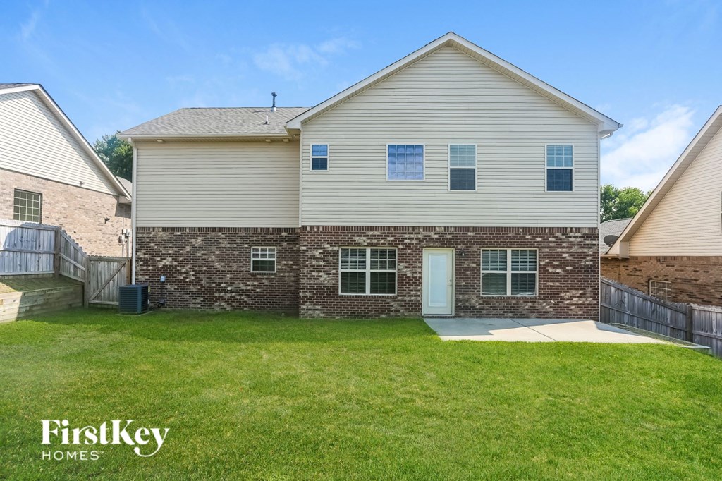 a brick and with a grass yard and a backdoor