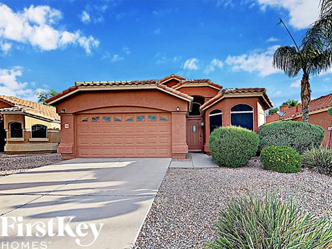 a single story home with a garage and a driveway