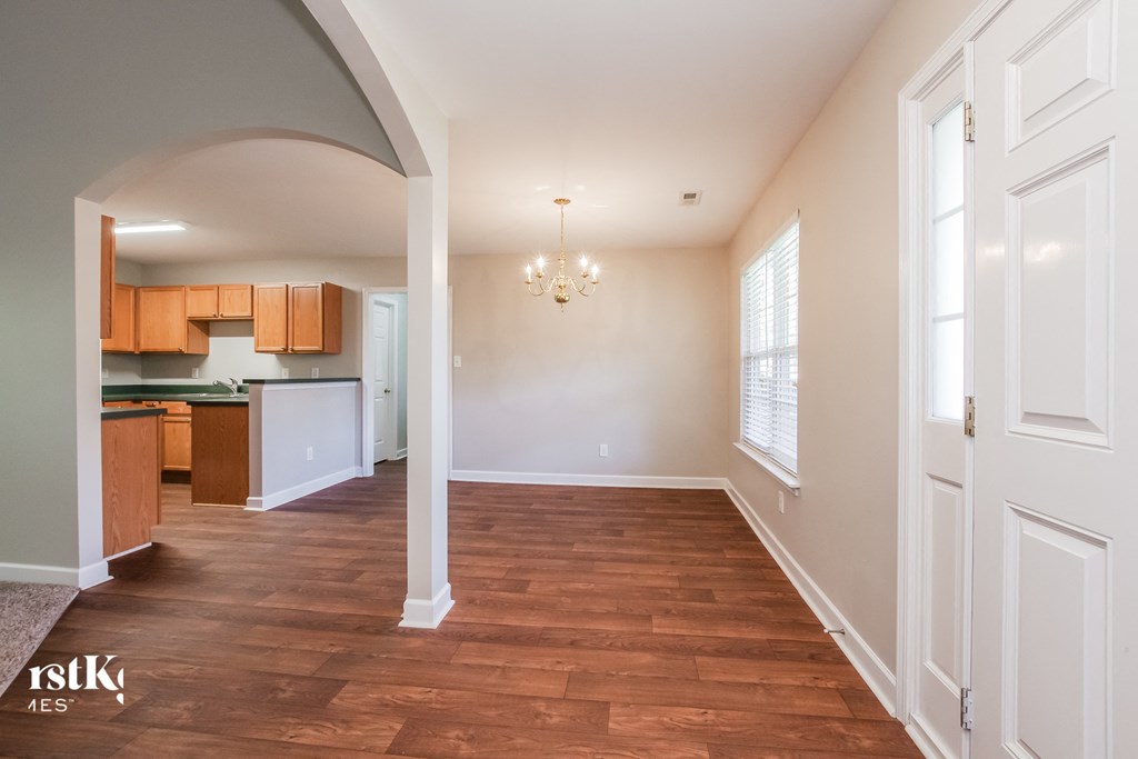 A room with wooden floors and white walls.