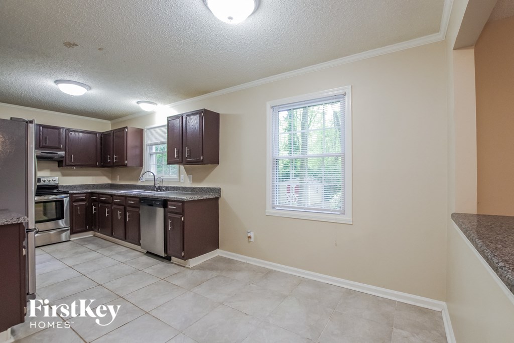a kitchen with a sink and a stove and a window