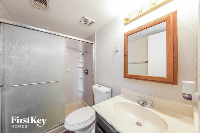 a bathroom with a sink toilet and a shower