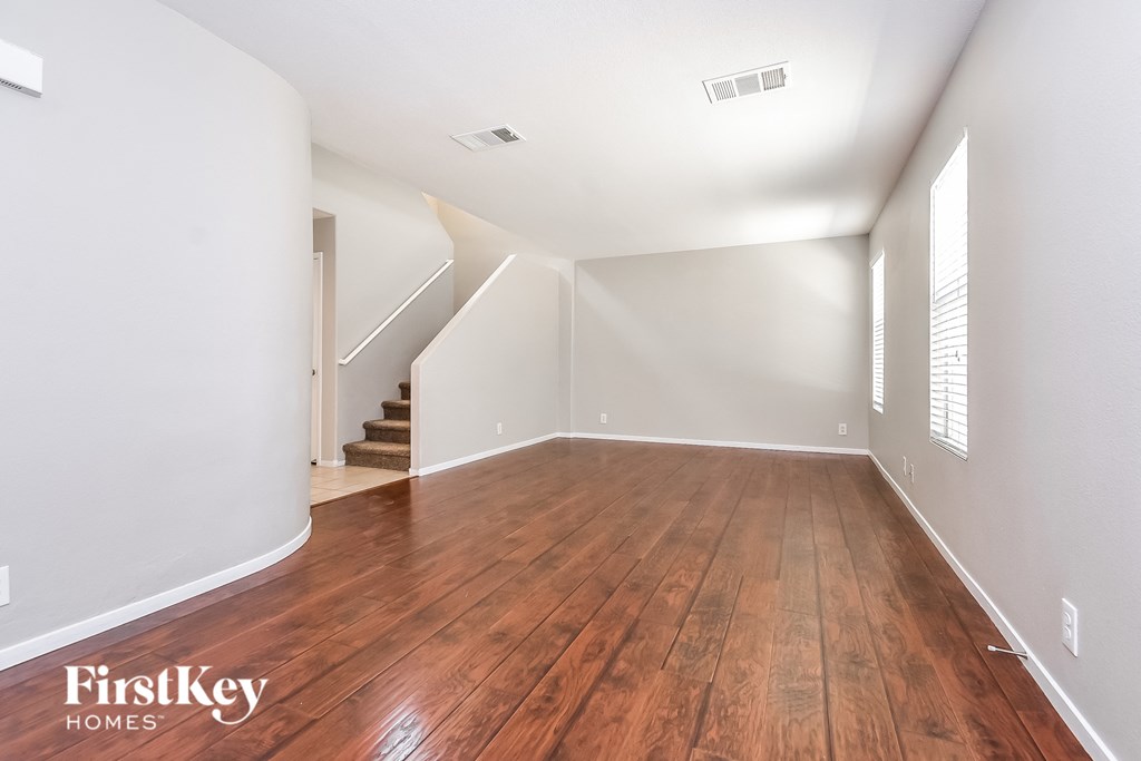 A room with wooden floors and white walls.