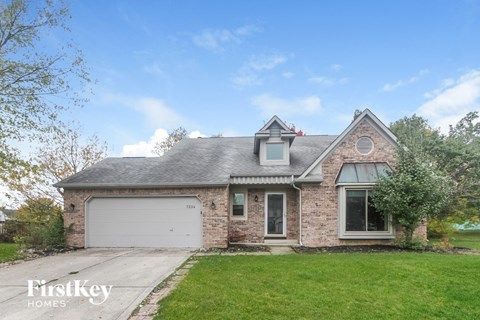 a brick house with a white garage door