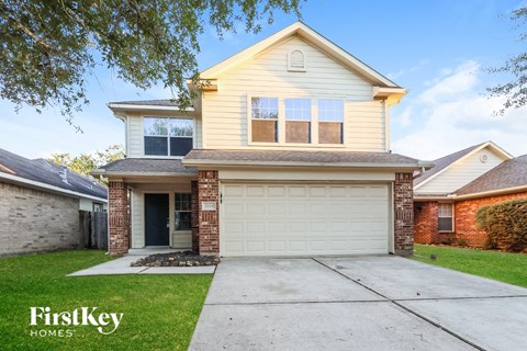 A two-story house with a garage is for sale.