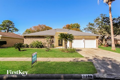 A house with a sign that says FirstKey Homes in front of it.