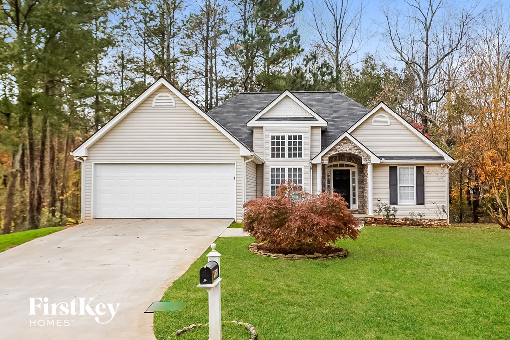 A house with a white garage door is for sale.