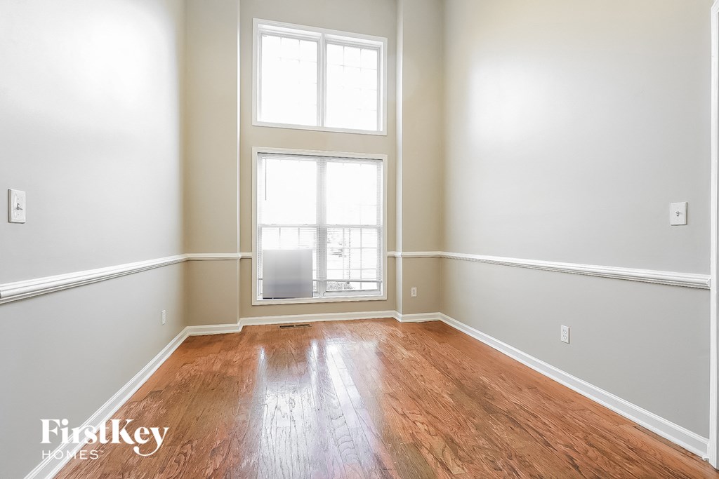 A room with wooden floors and a large window.