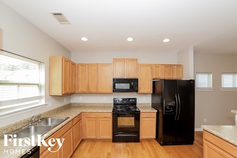 a kitchen with wooden cabinets and black appliances