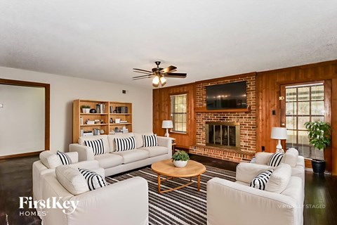 A living room with a fireplace and a television.