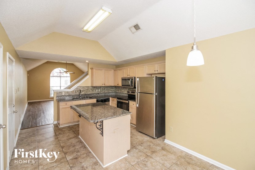 a kitchen with an island and stainless steel appliances