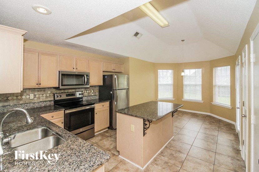 a kitchen with stainless steel appliances and granite counter tops