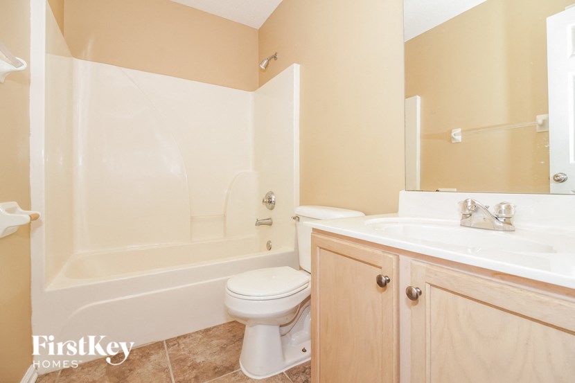 a bathroom with a sink toilet and a bath tub