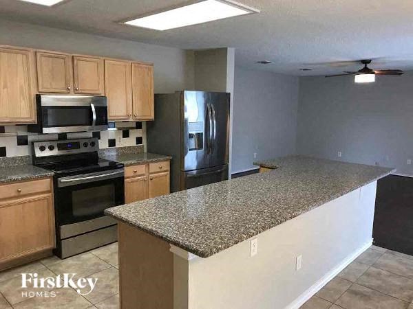 A kitchen with granite countertops and stainless steel appliances.