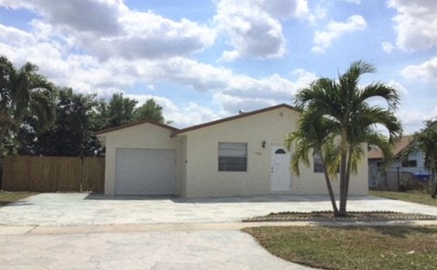 a house with a palm tree in front of it
