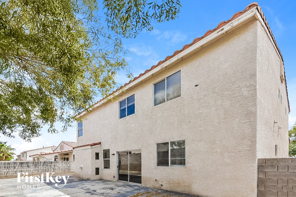 a large white building with a tree in front of it