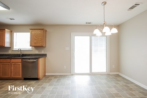 A kitchen with wooden cabinets and a black countertop.