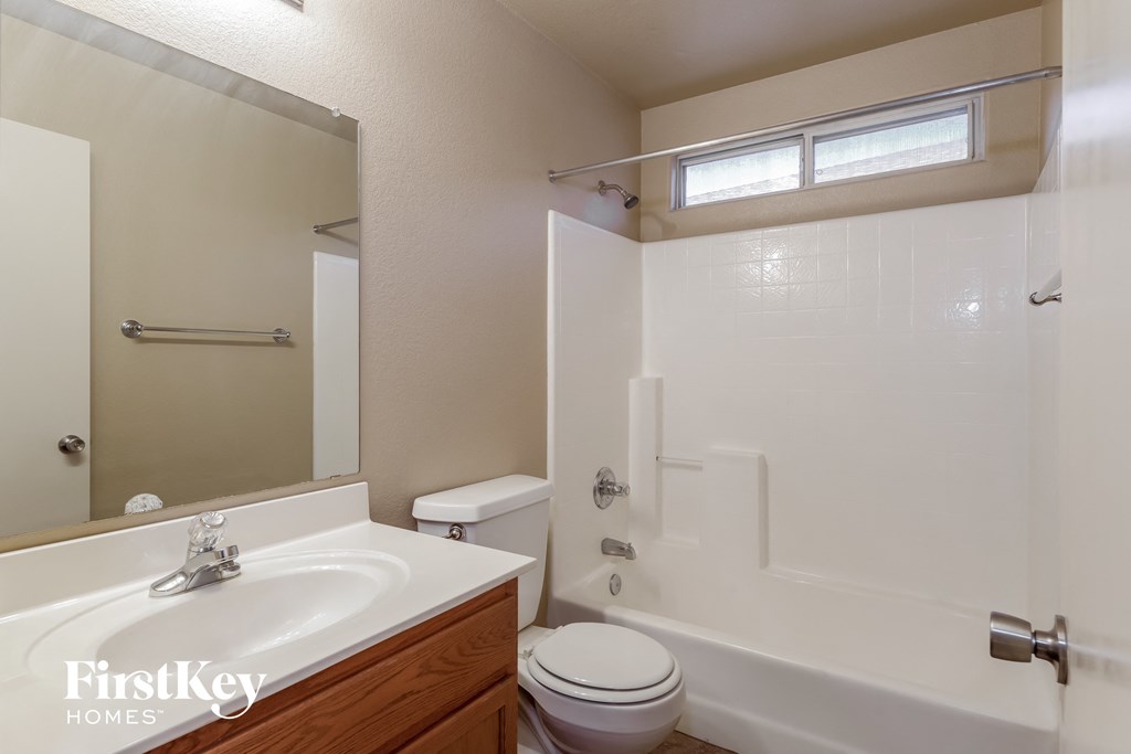 a bathroom with a sink toilet and a tub