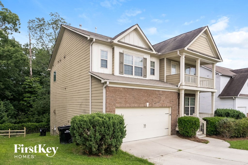 a tan house with a white garage door