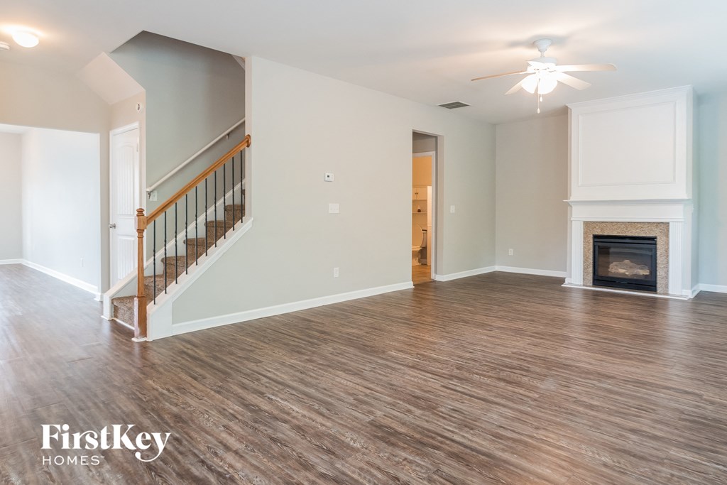 the living room of an empty house with a fireplace