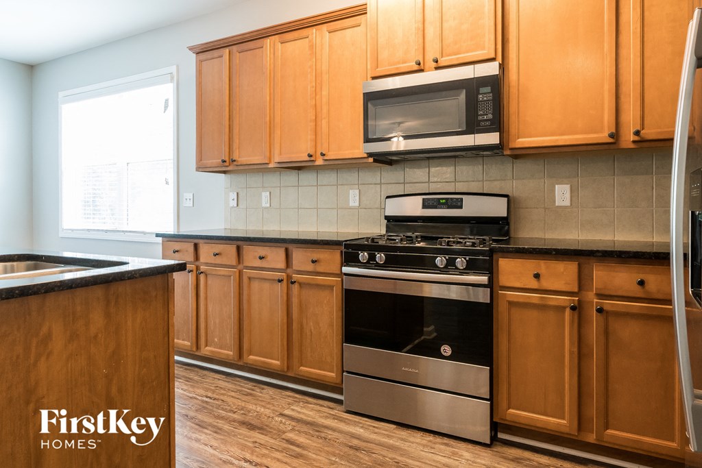 a kitchen with wooden cabinets and stainless steel appliances