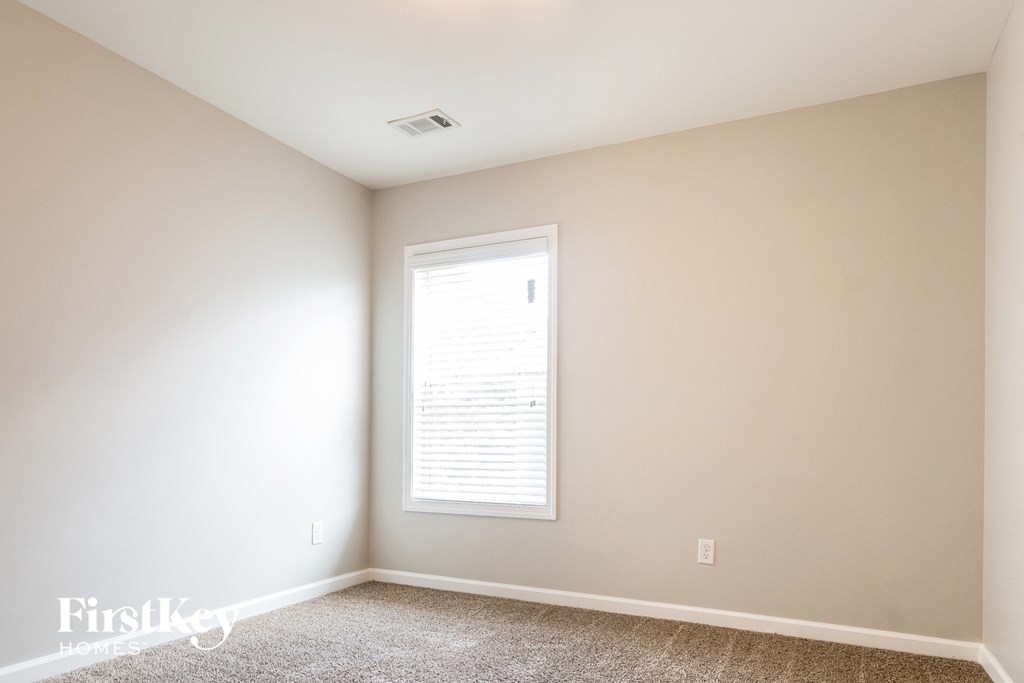 a empty room with white walls and a window