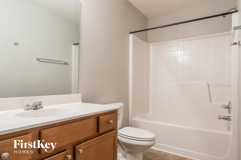 a bathroom with a toilet sink and a shower
