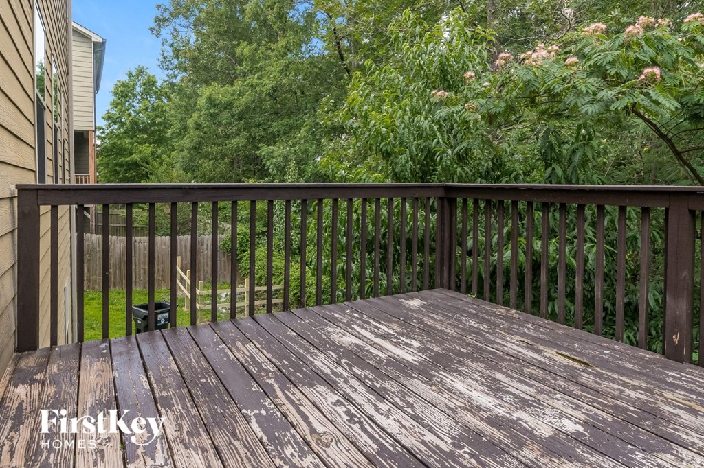 a deck with a view of trees and a yard