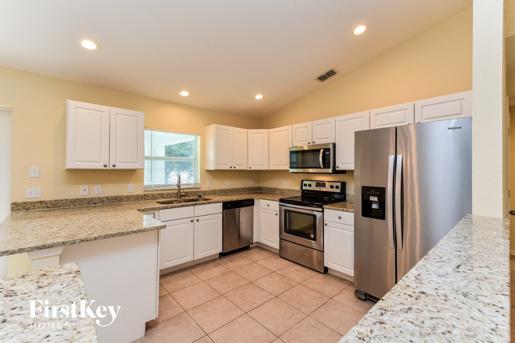a kitchen with stainless steel appliances and granite counter tops