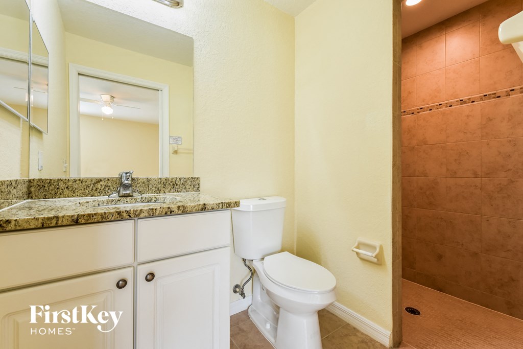 a bathroom with a toilet and a sink and a mirror