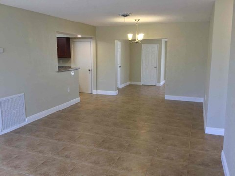 A room with beige walls and floor tiles.