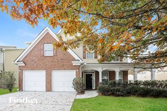 a large brick house with a white garage door