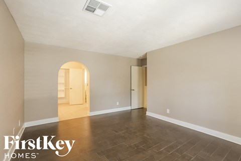 A spacious room with a FirstKey Homes logo.