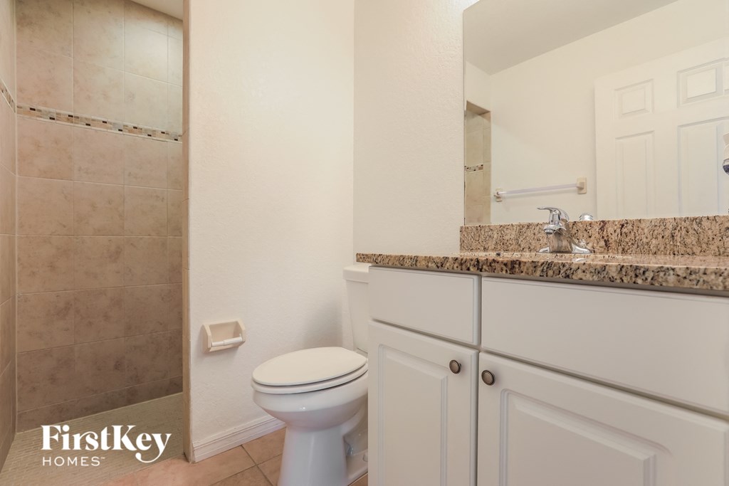 a bathroom with a toilet and a sink and a mirror