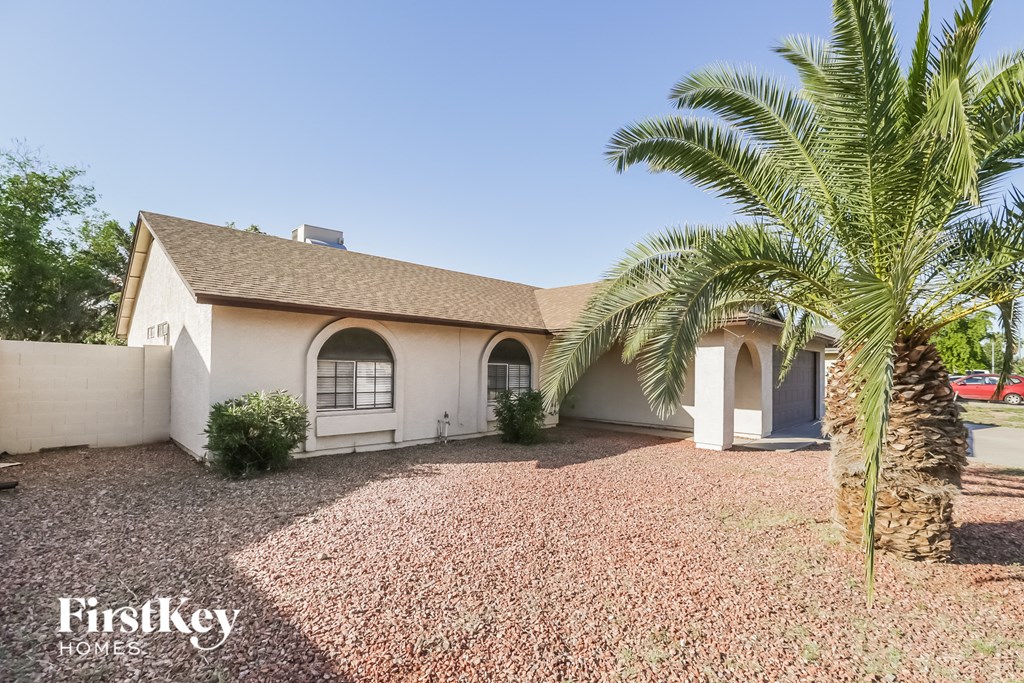 A house with a palm tree in front of it.