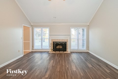 a living room with wood floors and a fireplace