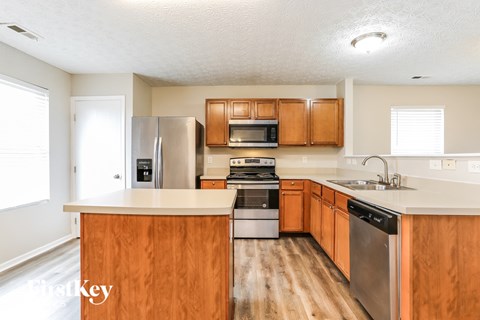 A kitchen with wooden cabinets and stainless steel appliances.