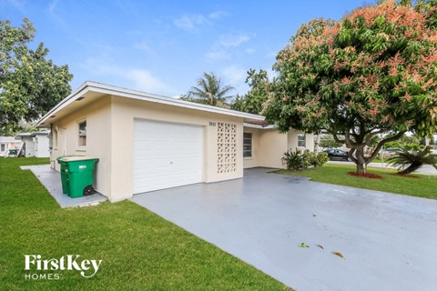 a home with a white garage door and a driveway