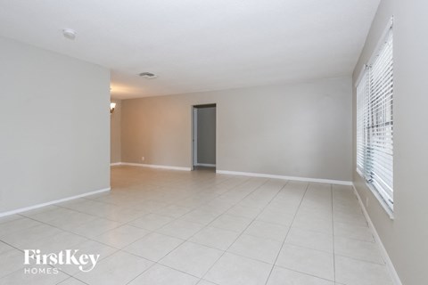 the living room and dining room of an empty house