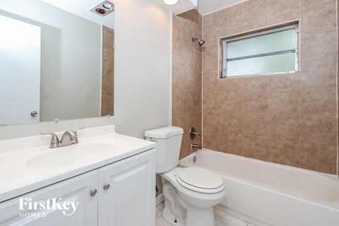 a bathroom with a sink toilet and a bath tub