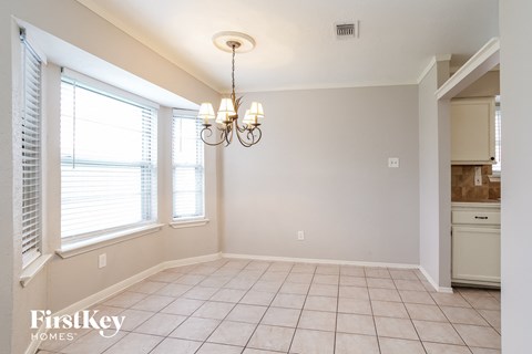 a dining room with a chandelier and a window