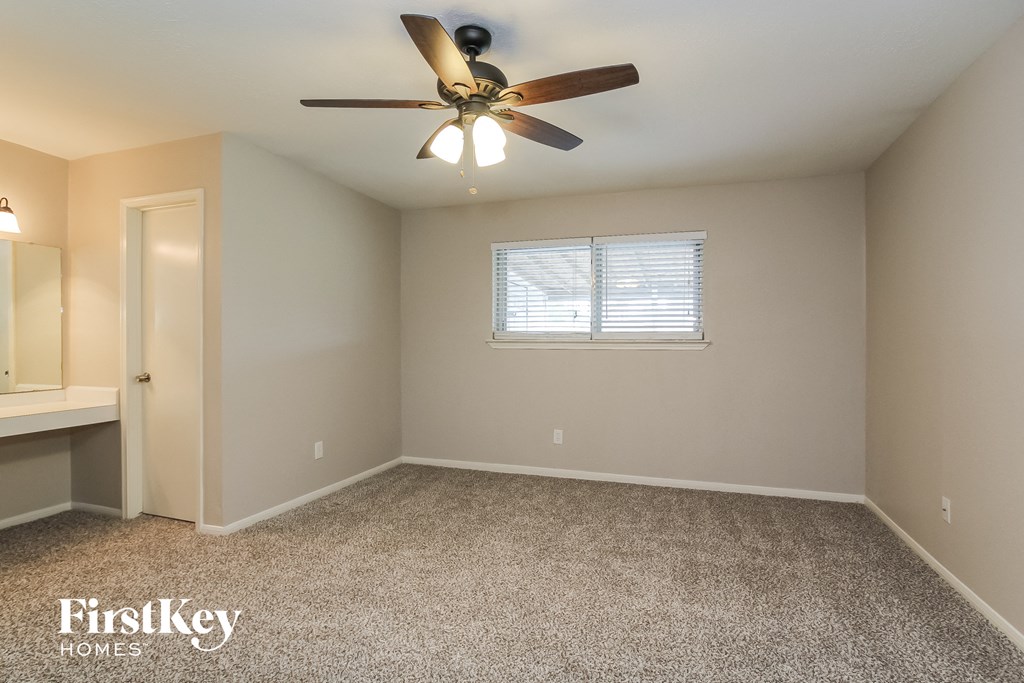 the master bedroom is spacious and has a ceiling fan