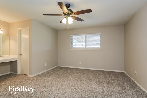 the master bedroom is spacious and has a ceiling fan