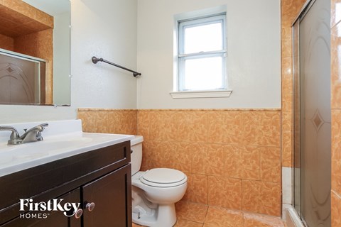 a bathroom with a toilet and a sink and a shower