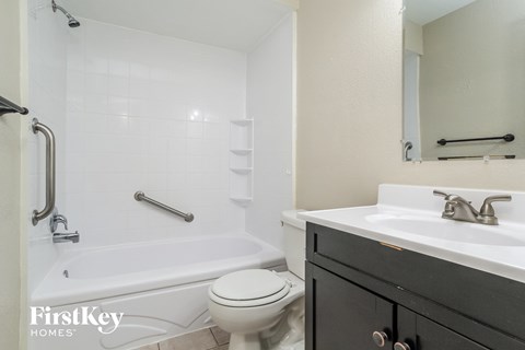 a bathroom with a sink toilet and a bath tub