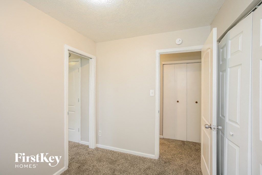 a bedroom with two closets and a door to a closet